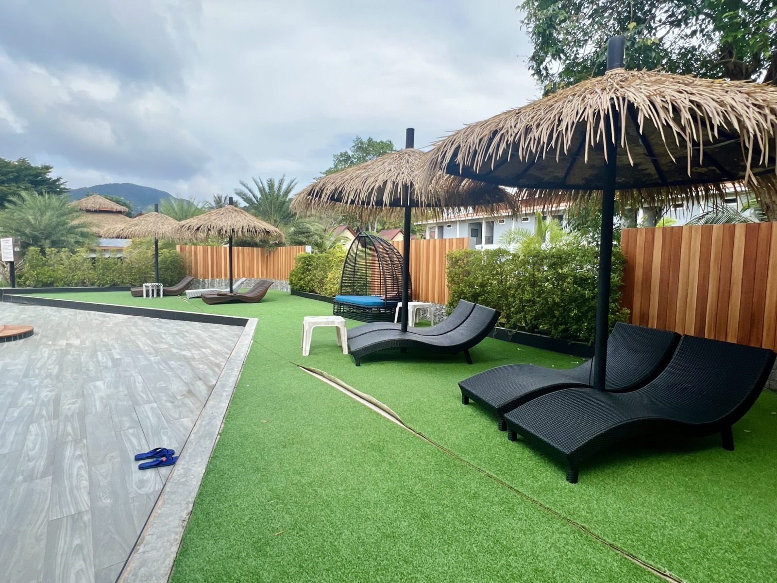 Artificial turf pool area kept clean on a maintenance plan