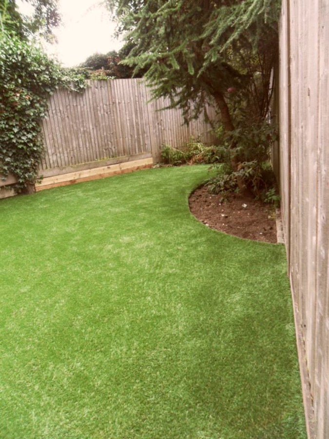 Artificial lawn with blades lifted after power brooming